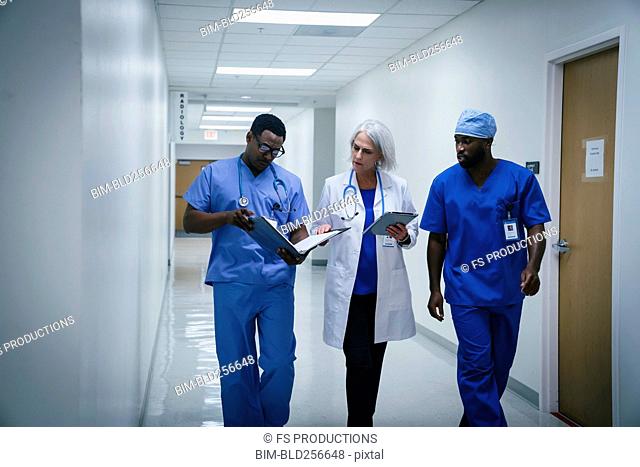Doctor and nurses discussing paperwork in hospital
