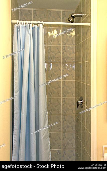Small Shower Cabin With Blue Curtains