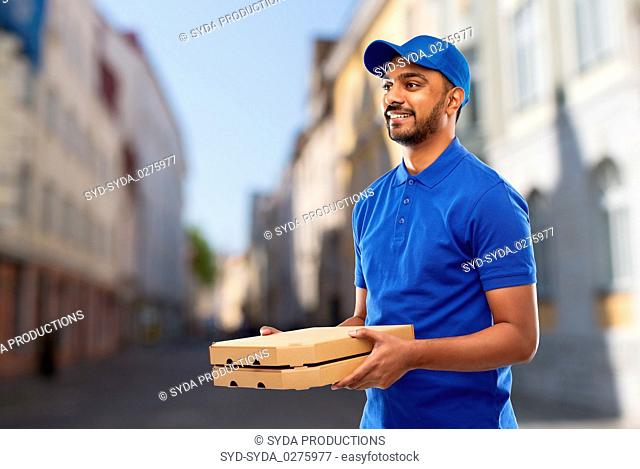 happy indian delivery man with pizza boxes in city
