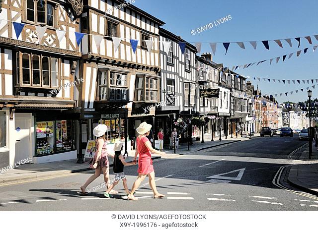 Medieval town, houses and shops of Ludlow, Shropshire, England. View down Broad Street from the Butter Cross on High Street