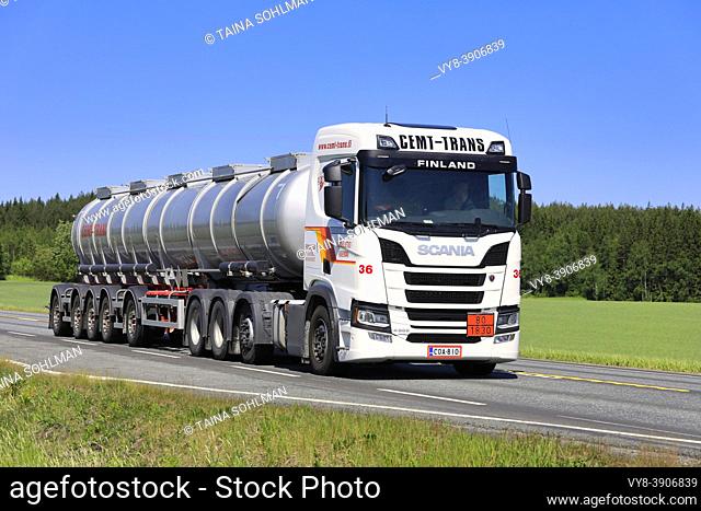 White new Scania R500 truck with long multi-axle tank trailer of Cemt-Trans at speed on Highway 2 on day of summer. Jokioinen, Finland. June 15, 2020