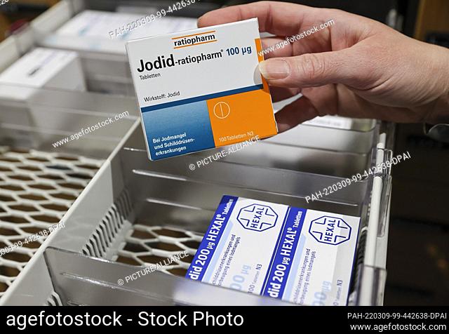 08 March 2022, Saxony, Leipzig: A pharmacist takes a pack of iodine tablets from a supply cabinet. The increased demand for iodine tablets in view of the war in...