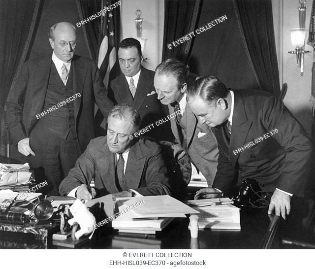 President Franklin Roosevelt signing the 1934 crime bill into law. Looking on from left: Attorney General Homer Cummings; J