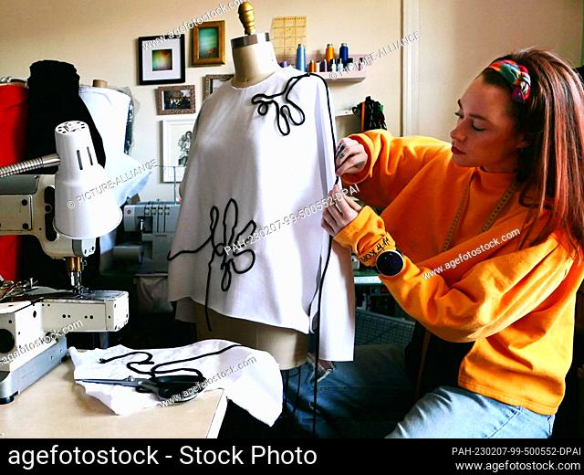 HANDOUT - 07 February 2023, USA, New York: German fashion tailor Janina Klahold works on a creation hanging on a dress mannequin in her sewing room (undated...