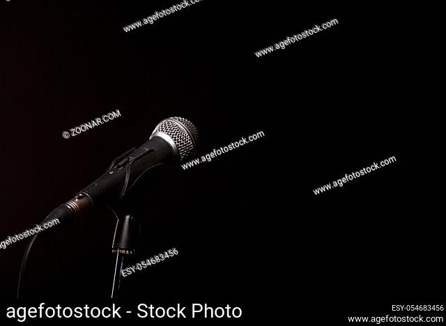 Photo of microphone on empty black background