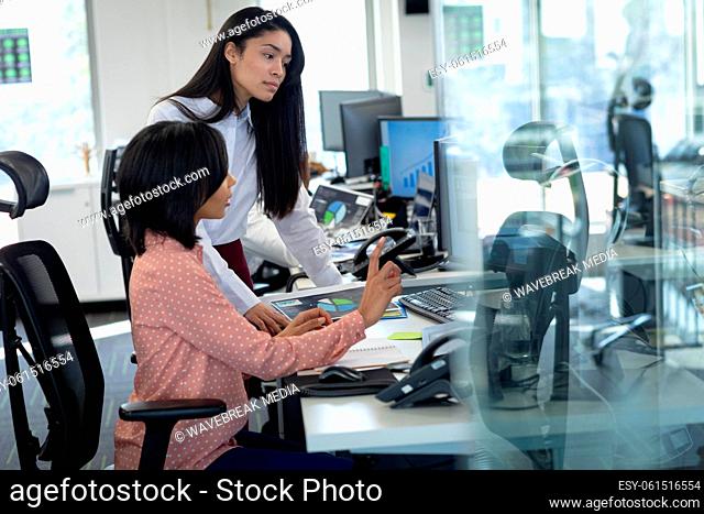 Two businesswomen working together at modern office