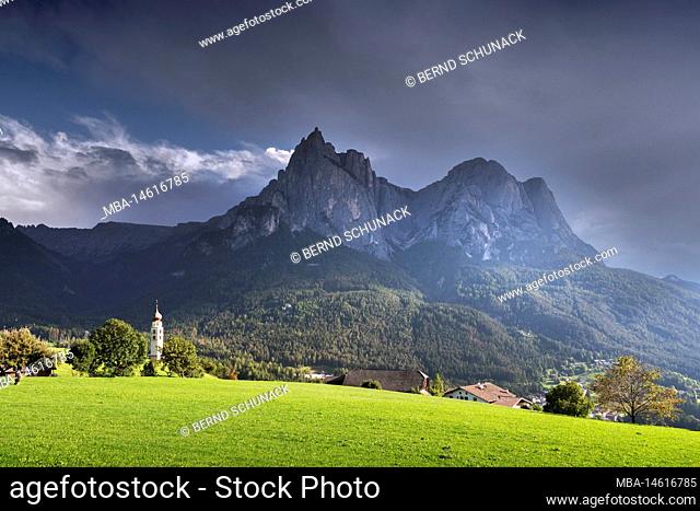 Church of St. Valentine with view towards Sciliar and Siusi with rising rain clouds