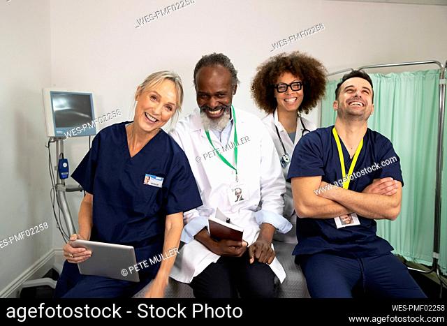 Cheerful doctors and nurses together in medical room