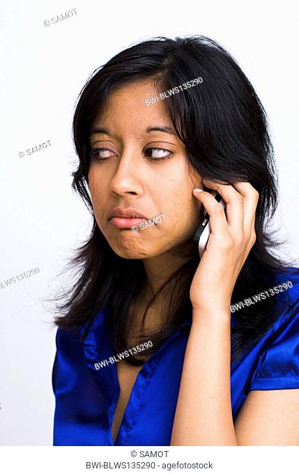 portrait of a dark-skinned woman with long hair phoning