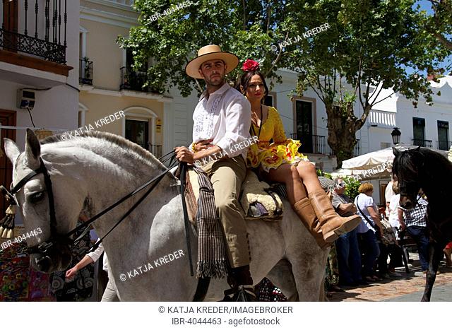 Man and woman on a horse, Romario de San Isidore pilgrimage in Nerja, Costa del Sol, Andalucia, Spain