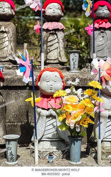 Jizo statues with red caps, protective deities for deceased children, Zojoji Temple, Buddhist temple complex, Tokyo, Japan, Asia