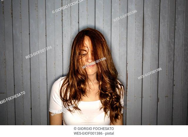 Redheaded young woman with dishevelled hair