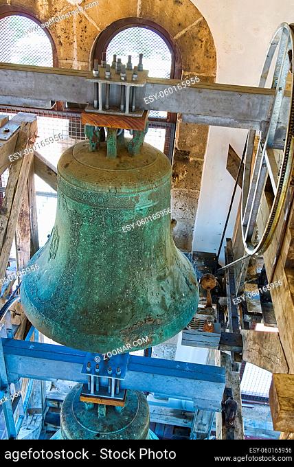 Middle age Traditional old bells in a church tower. Medieval bell and mounting construction. View of a bell situated on top of the tower