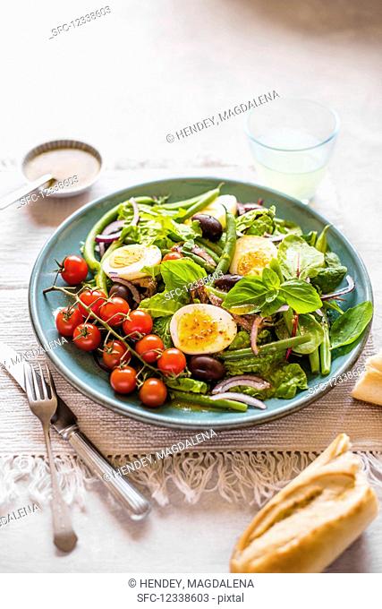 Nice salad with beans. Eggs, anchovies, olives and tomatoes