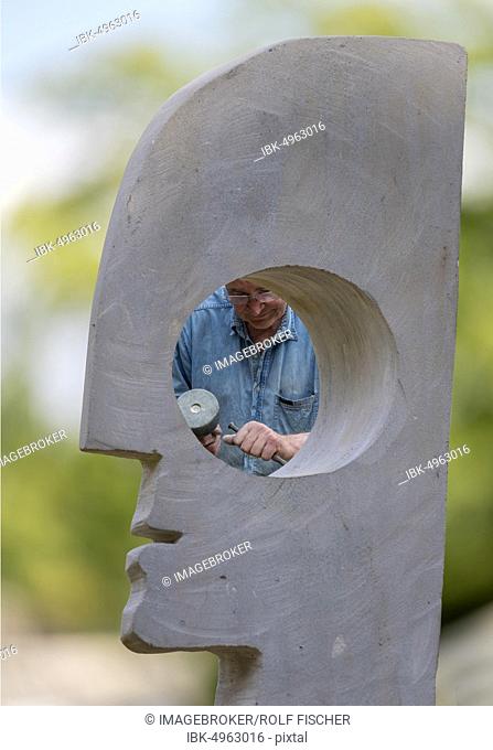 Sculptor works with hammer and chisel on head, sculpture, Germany, Europe