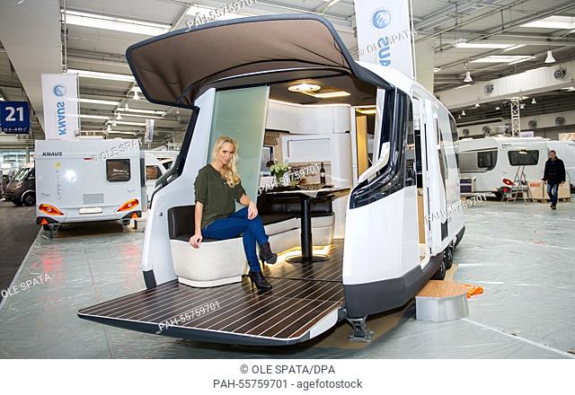Model Miriam poses in a Caravisio camper during the press tour of the abf Leisure Fair in Hanover, Germany, 10 February 2015