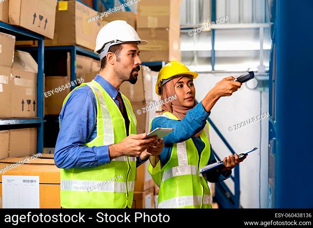 Middle east turkish white warehouse manager working about inventory with Islam asian warehouse worker in distribution center