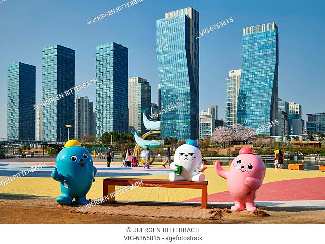 SOUTH KOREA, INCHEON CITY, 19.04.2019, oversized colorful toy figures in Central Park in Songdo International Business District with skyscraper in the back