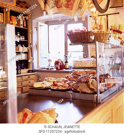 A rustically furnished shop floor with baked goods and other items for sale