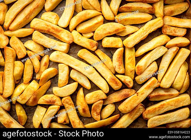 Big french fries. Fried potato chips. Top view