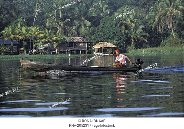 Man in traditional boat in the Tortuguero National Park on the Caribbean Coast of Costa Rica