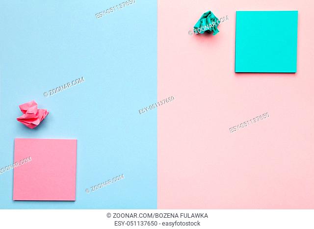 Sticky notes with crumbled paper balls on pastel background. Minimal style. Flat lay. Copy space. Top view