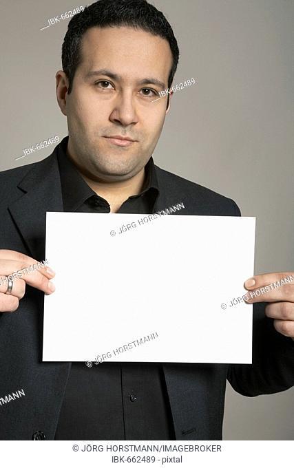 Man holding a blank sheet of paper