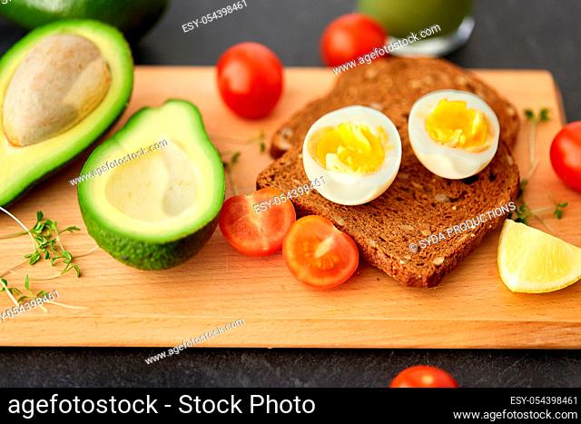 toast bread with eggs, cherry tomatoes and avocado