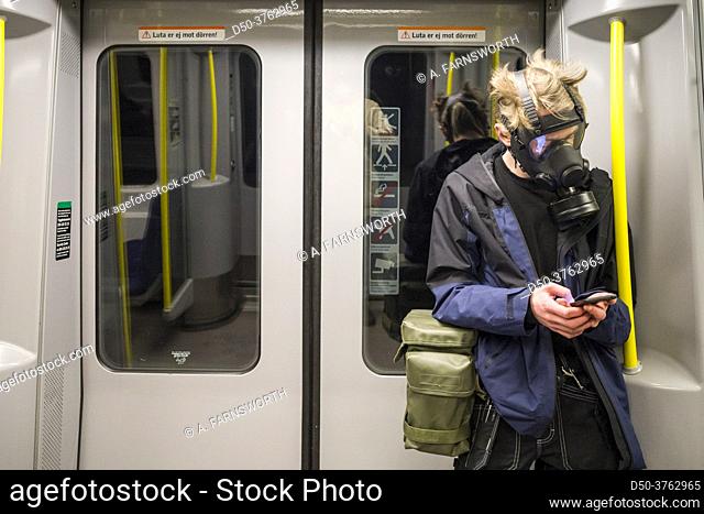Stockholm, Sweden A man in the tunnelbana or subway wearing a full-fledged gas mask