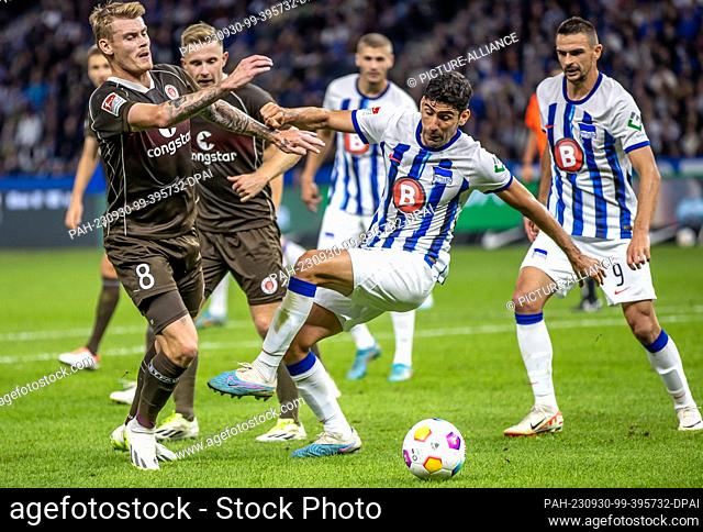 30 September 2023, Berlin: Soccer: 2nd Bundesliga, Hertha BSC - FC St. Pauli, Matchday 8, Olympiastadion. FC St. Pauli's Eric Smith (l) is tackled hard by...