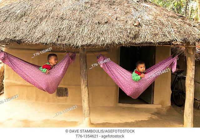 cute boys in hammocks in a Tharu village in Chitwan National Park in Nepal