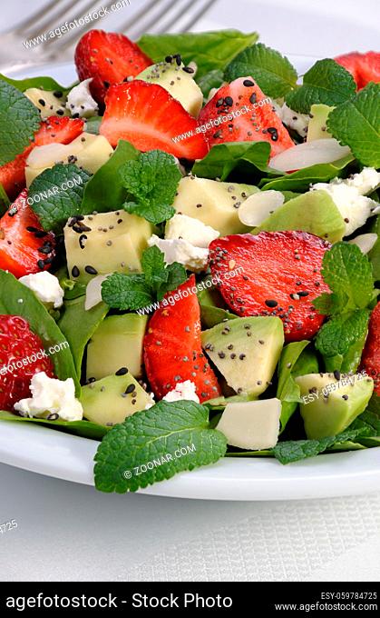 Salad spinach with strawberries, avocado, mint, ricotta and sesame, poppy seeds