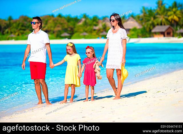 Happy beautiful family on a beach during summer vacation