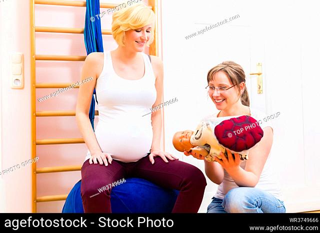 Midwife giving pregnant woman antenatal care for childbirth in practice