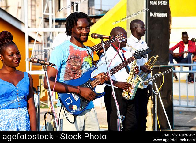 Der regional bekannte ugandische Saenger und Gitarrist Mukisa John Mary während seines Auftritts beim Orupaap Nature Arts Festival, aufgenommen am 07