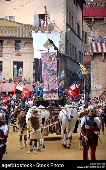 Palio di Siena. The riders carry the Palio which will go to the winner of the race. Siena (Italy), August 17th, 2022