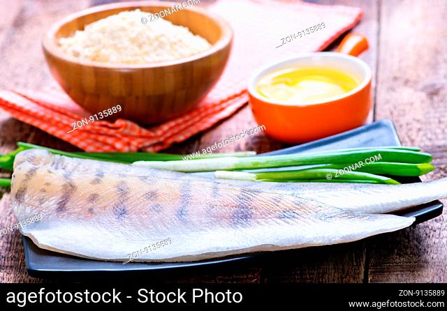 raw fish on plate and on a table