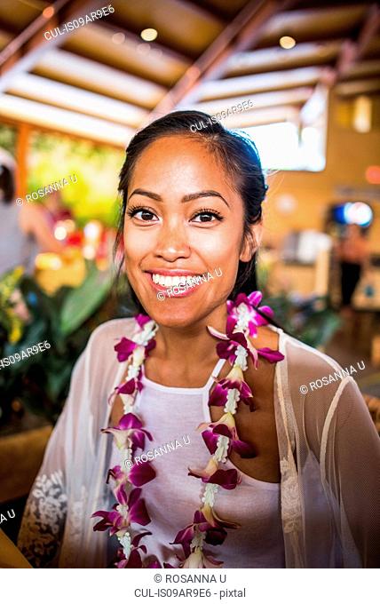 Portrait of young woman wearing flower lei in Polynesian Cultural Centre, Hawaii, USA