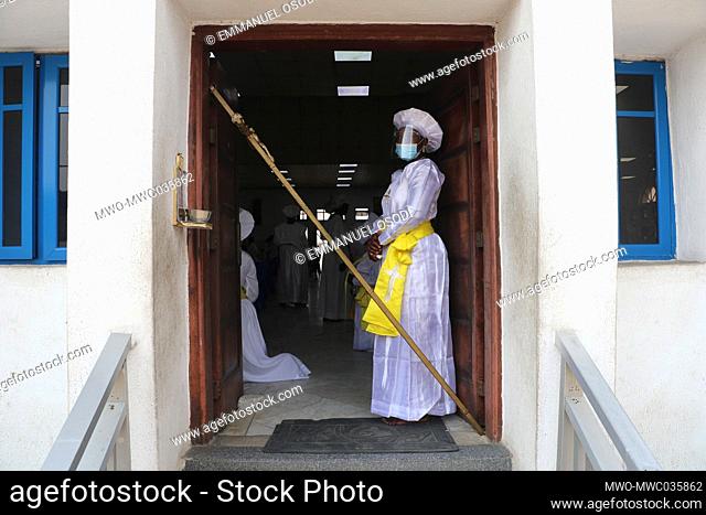 A church official stand at the entrance of a church to ensure and enforce the coronavirus preventive protocols. Christians on Sunday gathered to pray at...
