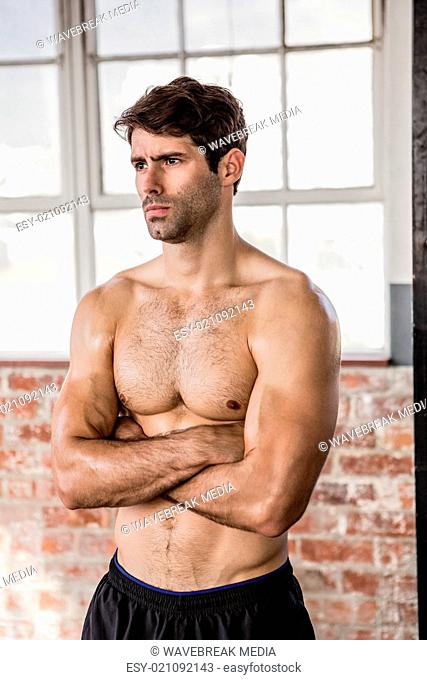 Shirtless man with arms crossed