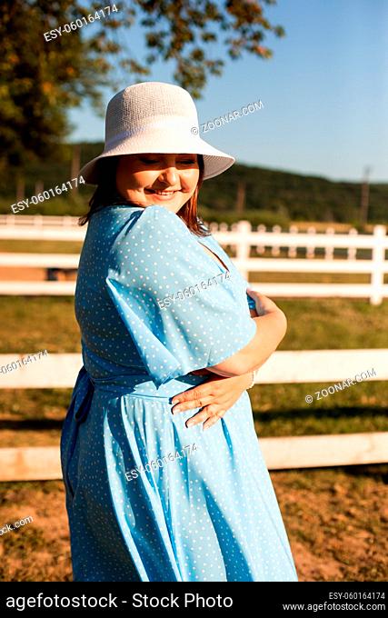 Candid woman in hat at farmland enjoy the life in summer