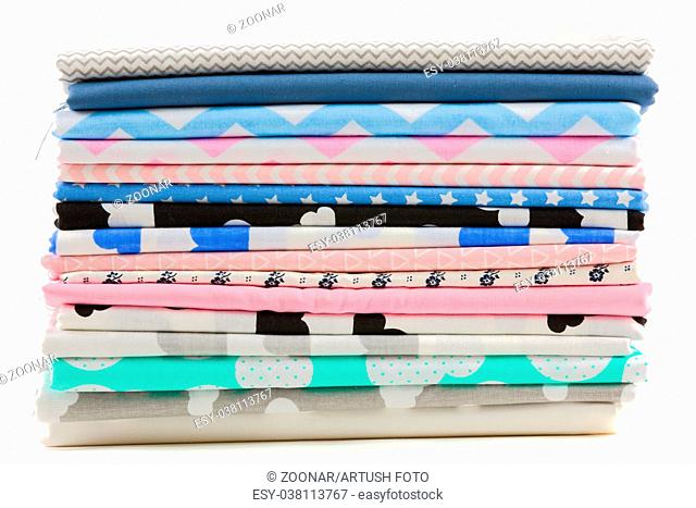Stack of cotton fabric material isolated on white