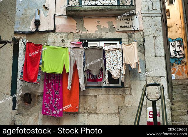 narrow streets with laundry hanging to dry in Alfama neighbourhood, Lisbon, Portugal