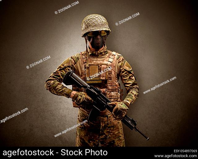 Soldier agent in a dark room with arms on his hand and gas mask