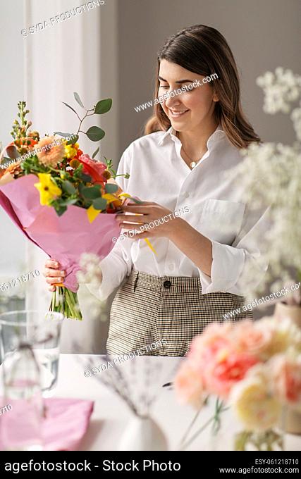 happy woman with bunch of flowers at home