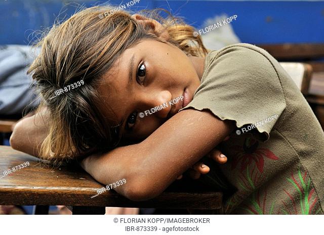 Girl resting on a school bench, Realejo, Departamento Chinandega, Nicaragua, Central America