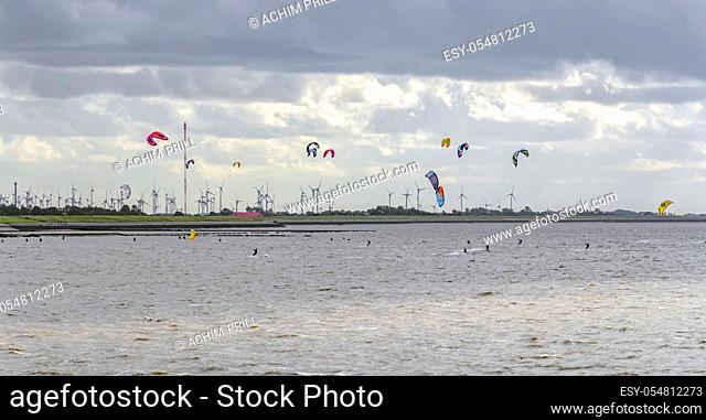 stormy coastal scenery including some kitesurfers near Neuharlingersiel in Eastern Frisia, Germany