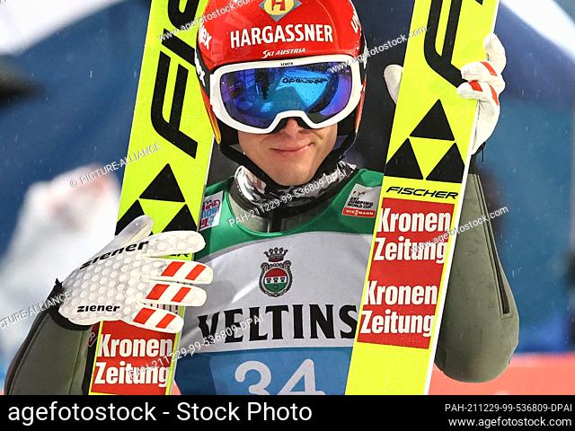 29 December 2021, Bavaria, Oberstdorf: Nordic skiing/ski jumping: World Cup, Four Hills Tournament. Philipp Aschenwald from Austria reacts after his jump in the...