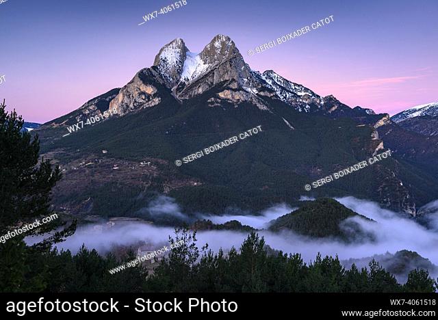 Winter sunrise in snowy Pedraforca and fog over Saldes valley (Barcelona province, Catalonia, Spain, Pyrenees)