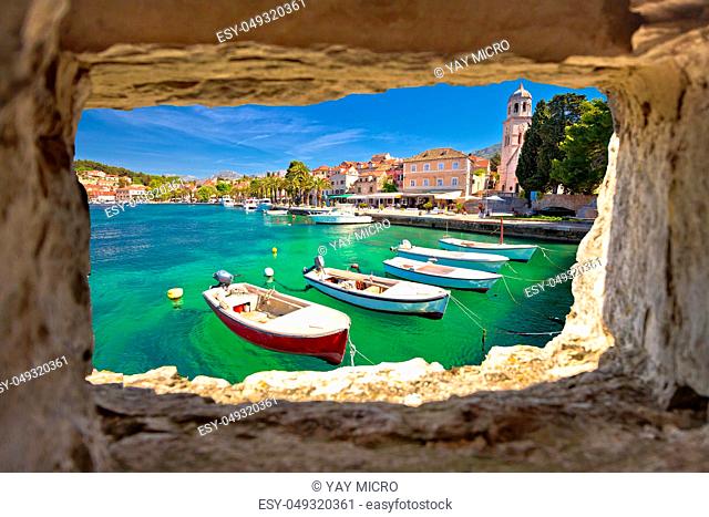 Turquoise waterfront of Cavtat view through stone window, Dalmatia, Croatia